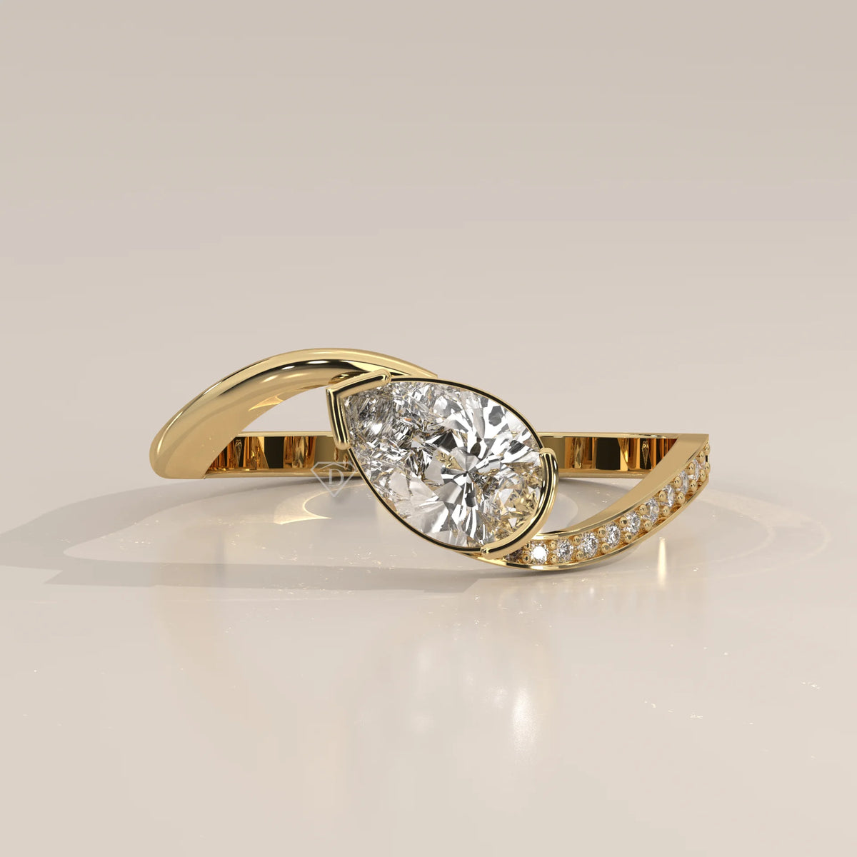 Pear Lab Grown Diamond Bypass Ring with Half Bezel and Pave Shoulder in yellow gold, shown at an angle.