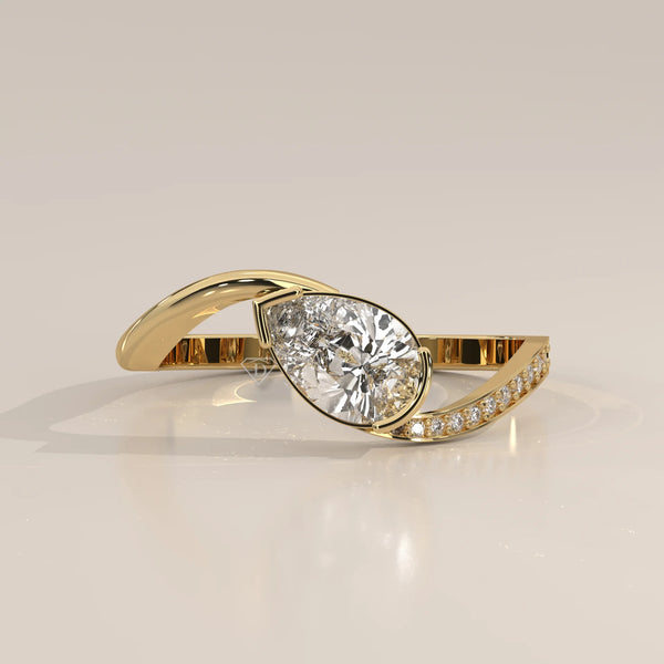 Pear Lab Grown Diamond Bypass Ring with Half Bezel and Pave Shoulder in yellow gold, shown at an angle.