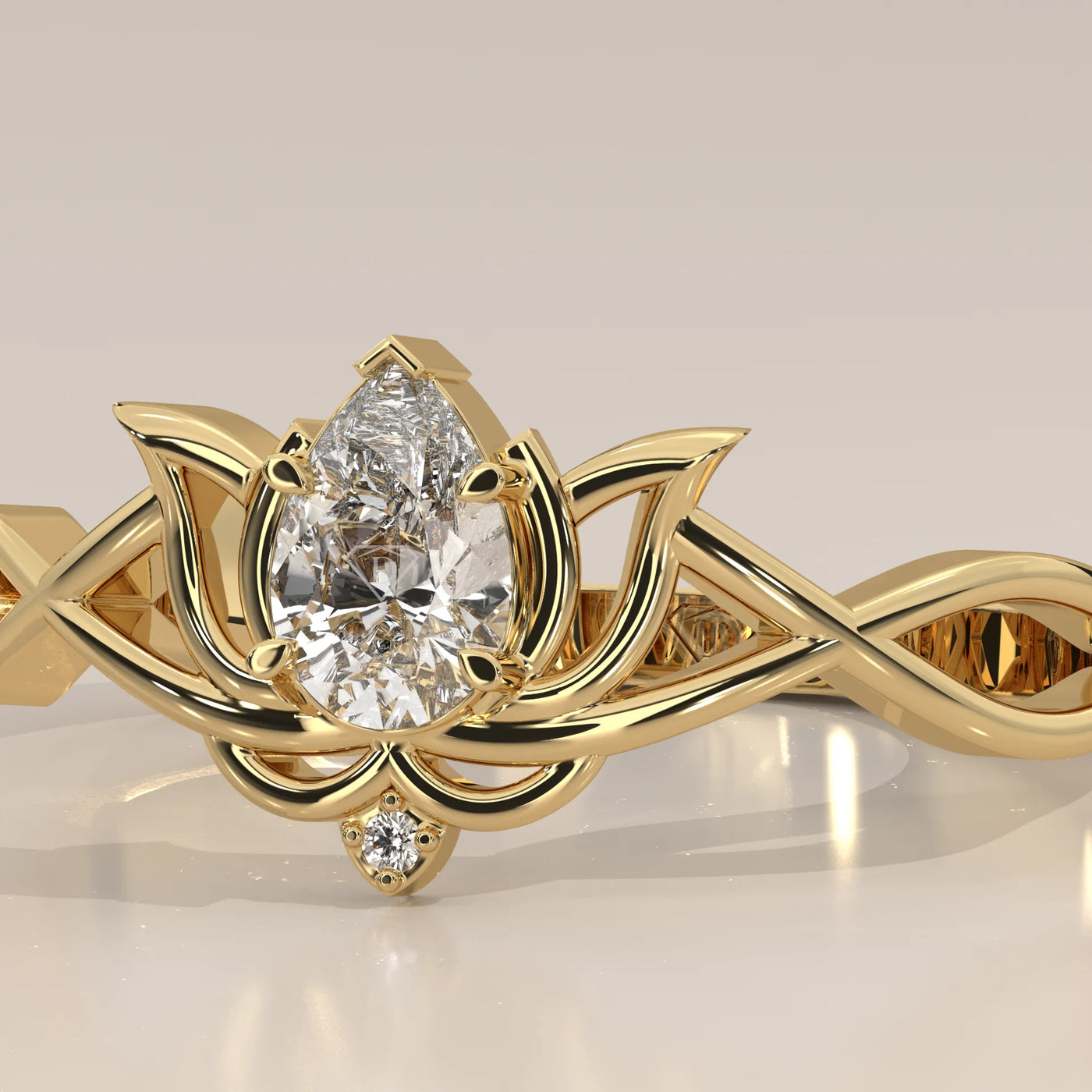 Close-up of a 14k yellow gold ring with a pear-shaped diamond.