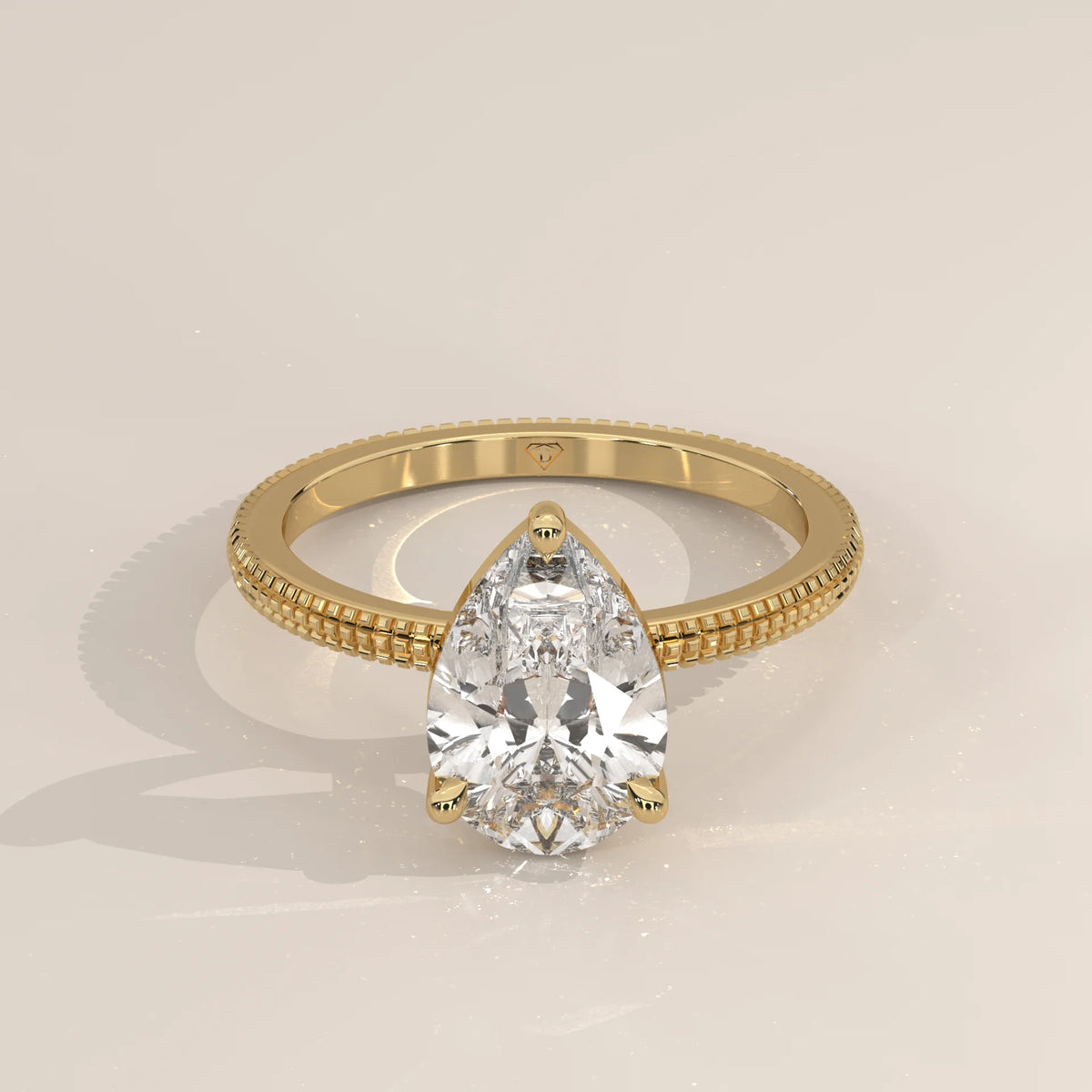 Pear-shaped diamond engagement ring in yellow gold with pave band.