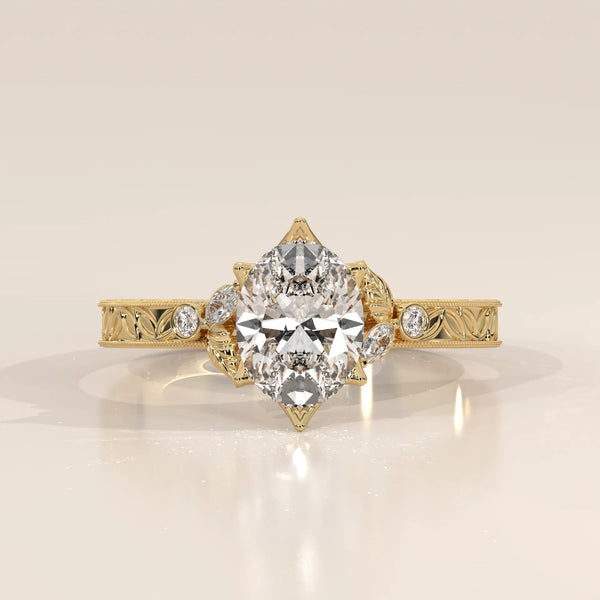 Pear shaped diamond engagement ring in yellow gold with intricate detailing.