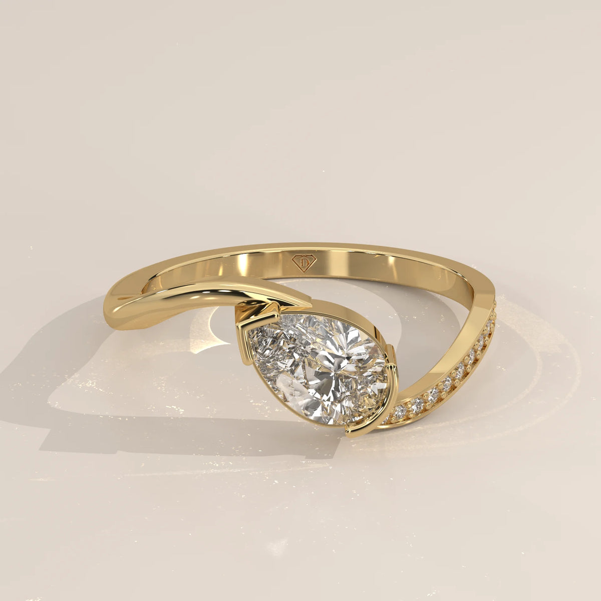 Pear Lab Grown Diamond Bypass Ring with Half Bezel and Pave Shoulder in yellow gold, shown from the side.