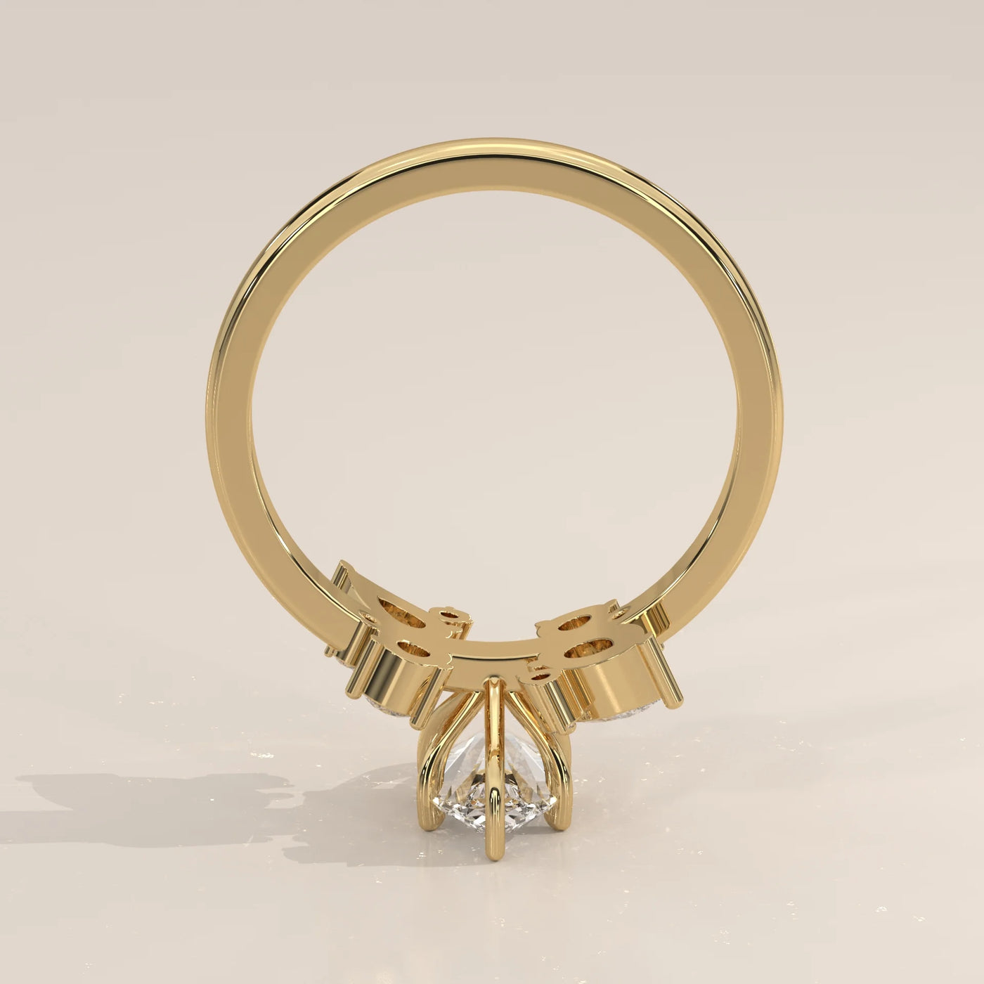 A pear-shaped diamond engagement ring in yellow gold.