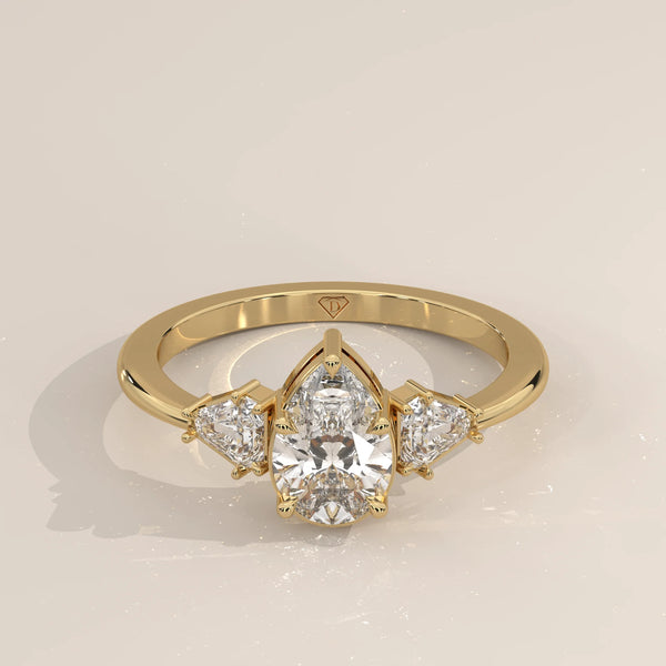 Pear Lab Grown Diamond Three Stone Ring with Shield Cut Sides in yellow gold, shown from the front.