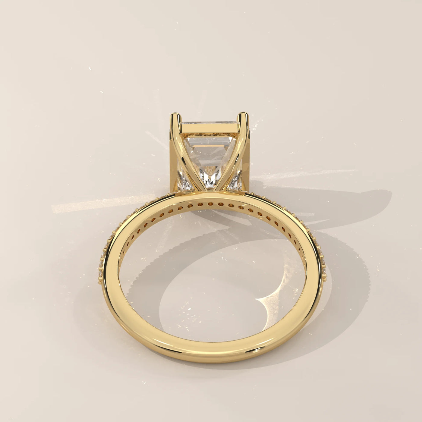 A yellow gold ring with a princess-cut diamond and pavé band.