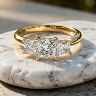 Flat Lay: Princess Diamond Ring with Three Stone Setting in 14k Yellow Gold - Lab Grown - Driona Jewels