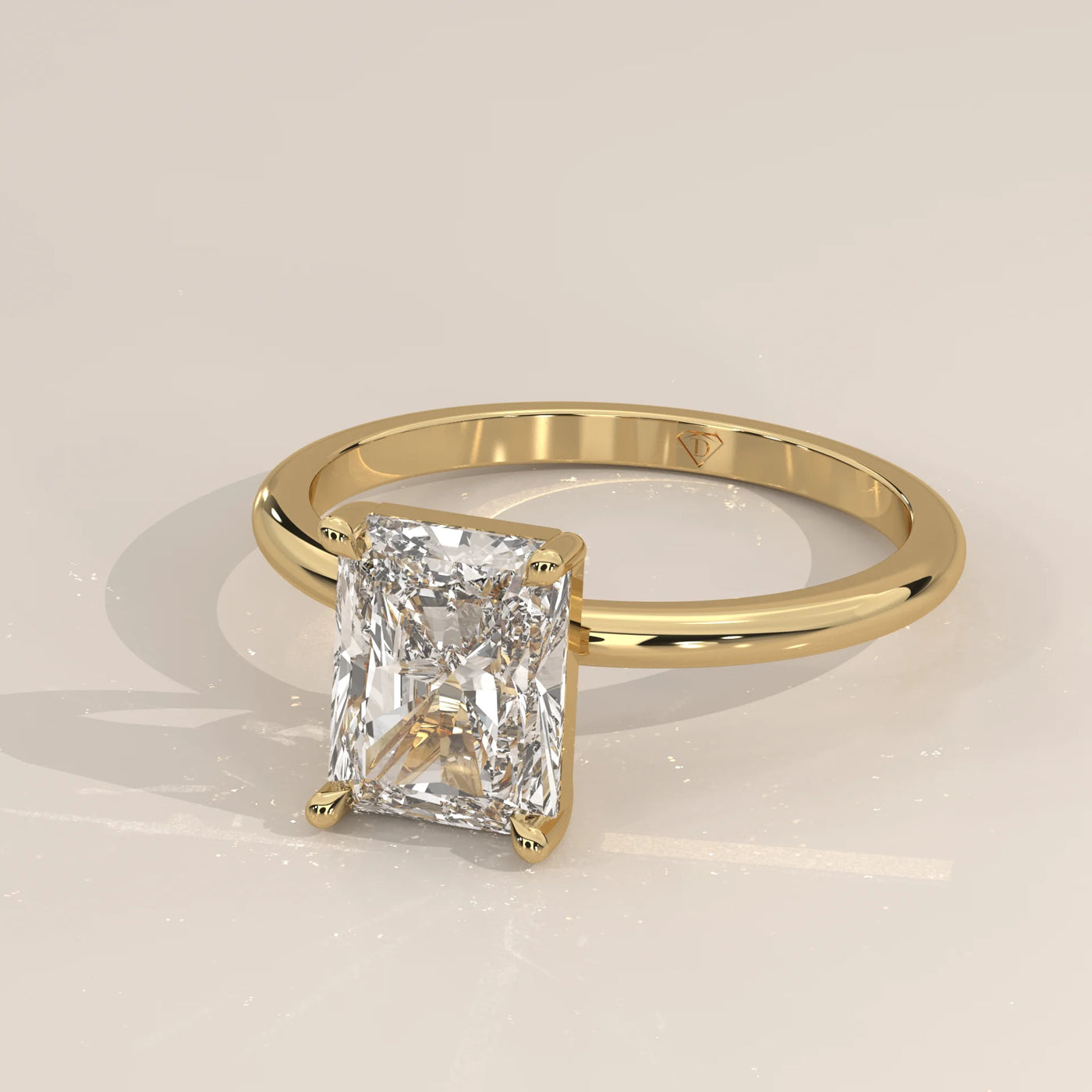 Yellow gold ring with a radiant cut diamond.