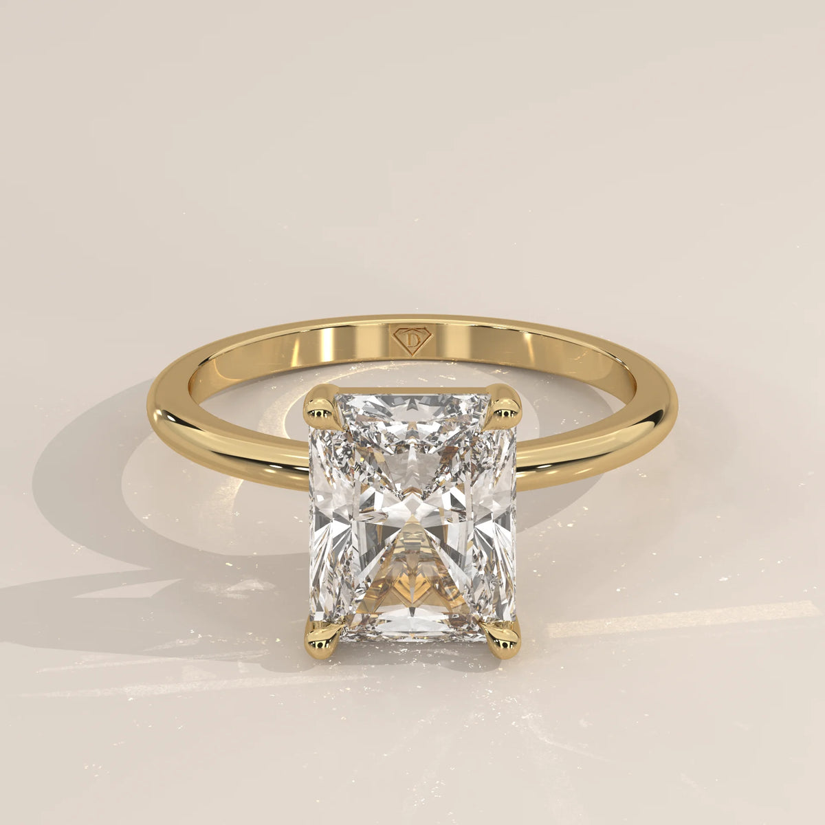 A radiant cut diamond engagement ring in yellow gold.