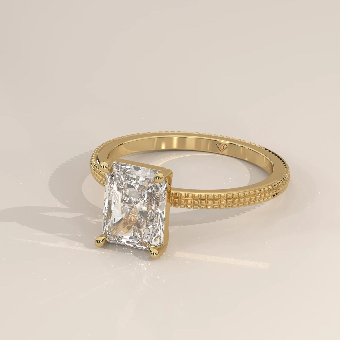 A yellow gold ring with a radiant cut diamond.