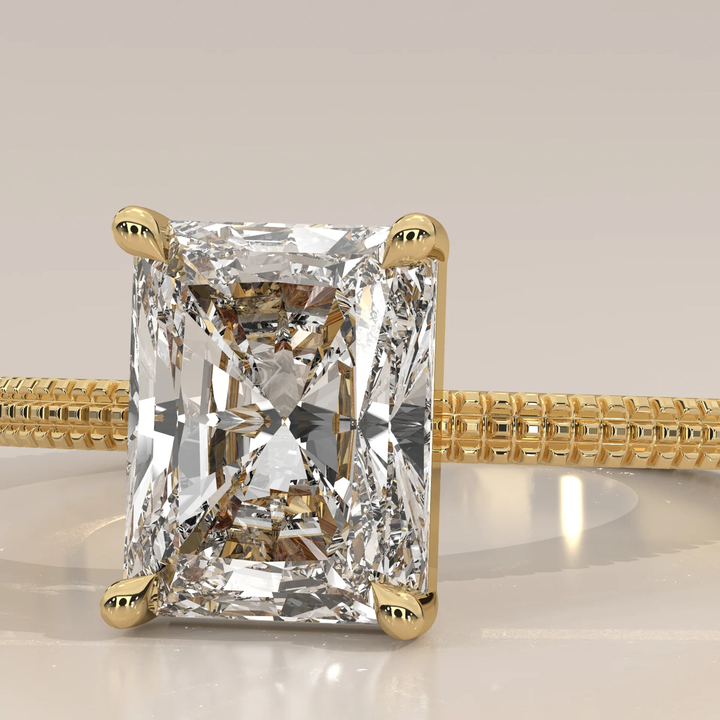 Close-up of a radiant cut diamond engagement ring in 14k gold.