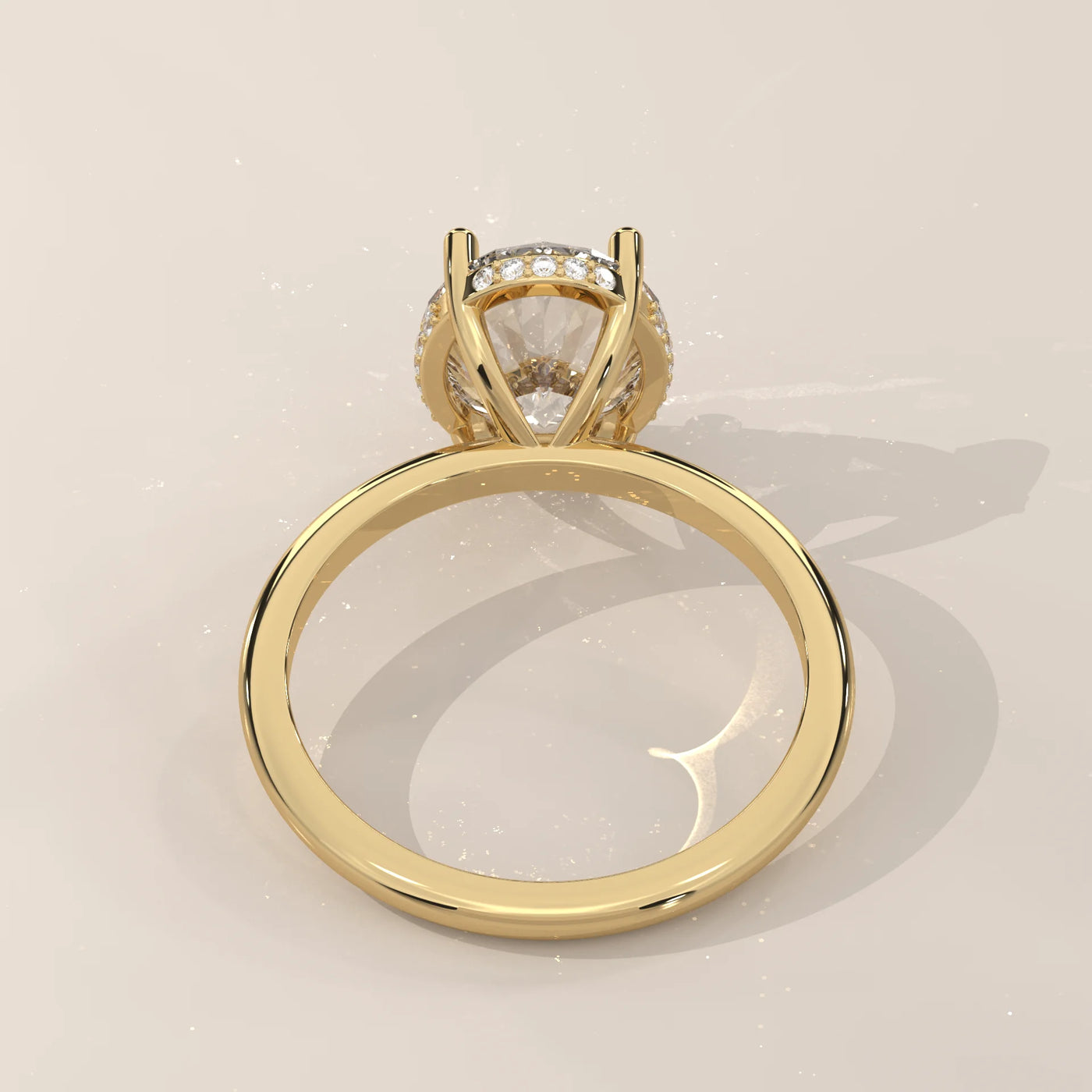 Round diamond engagement ring with pave band in yellow gold.