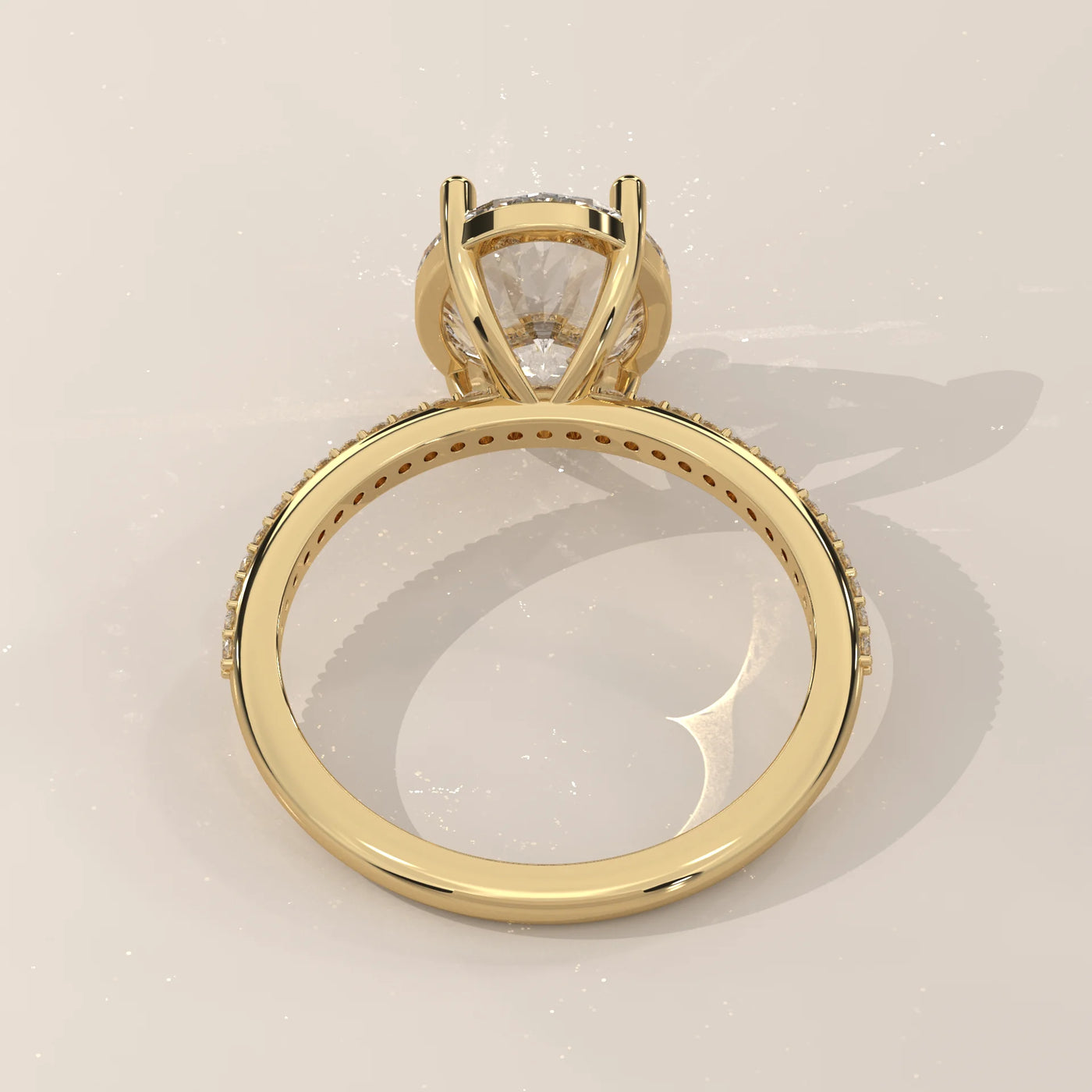 A 14k yellow gold ring with a large center diamond and pavé band.