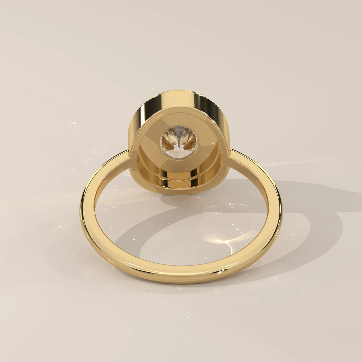 Oval Lab Grown Diamond Bezel Solitaire with Coin Edge Rim in yellow gold, shown on a plain background.