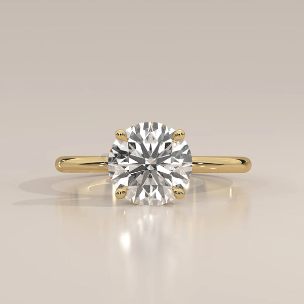 A classic solitaire diamond ring with a 14k gold band.