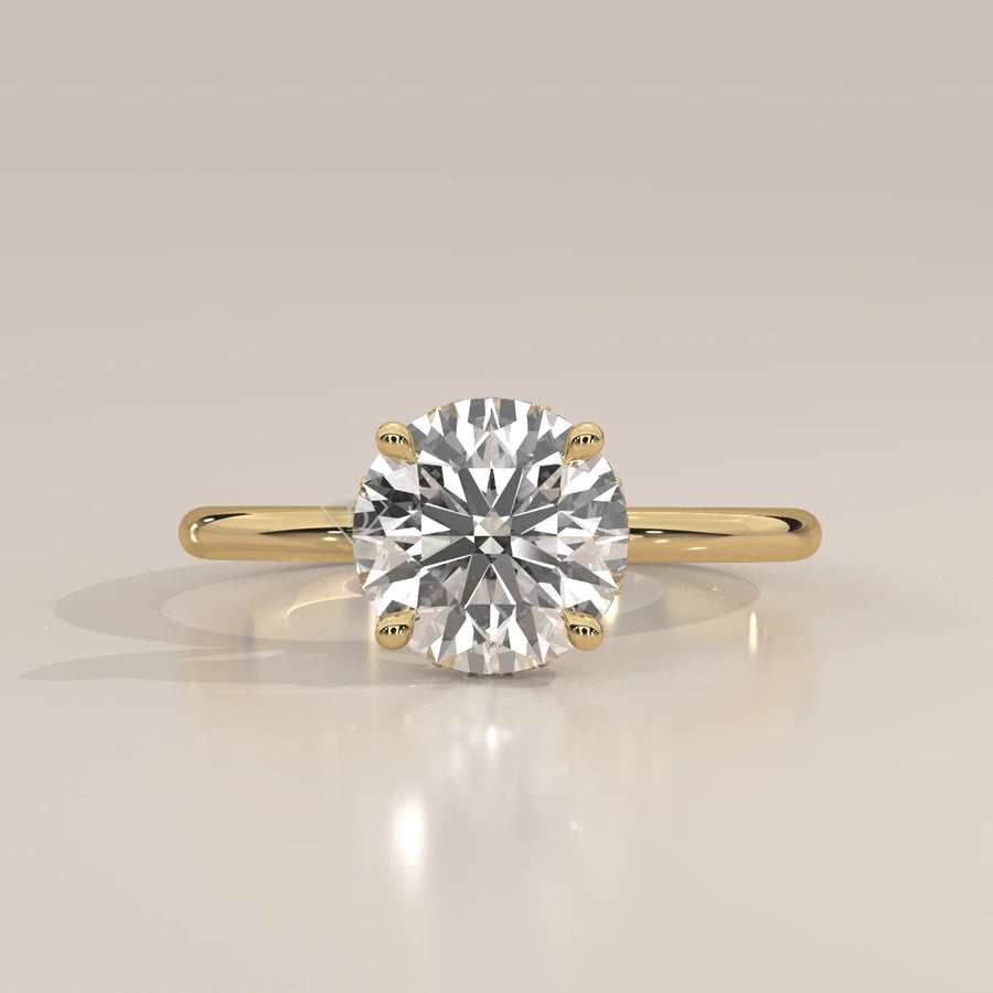 A classic solitaire diamond ring with a 14k gold band.