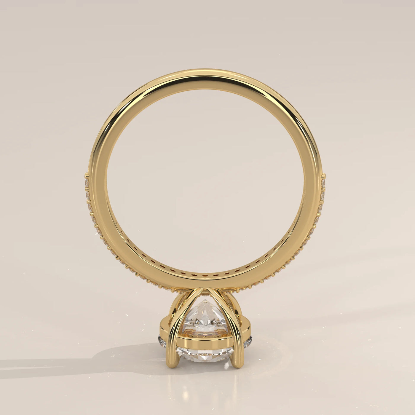 A classic 14k yellow gold ring with a large diamond and pave band.