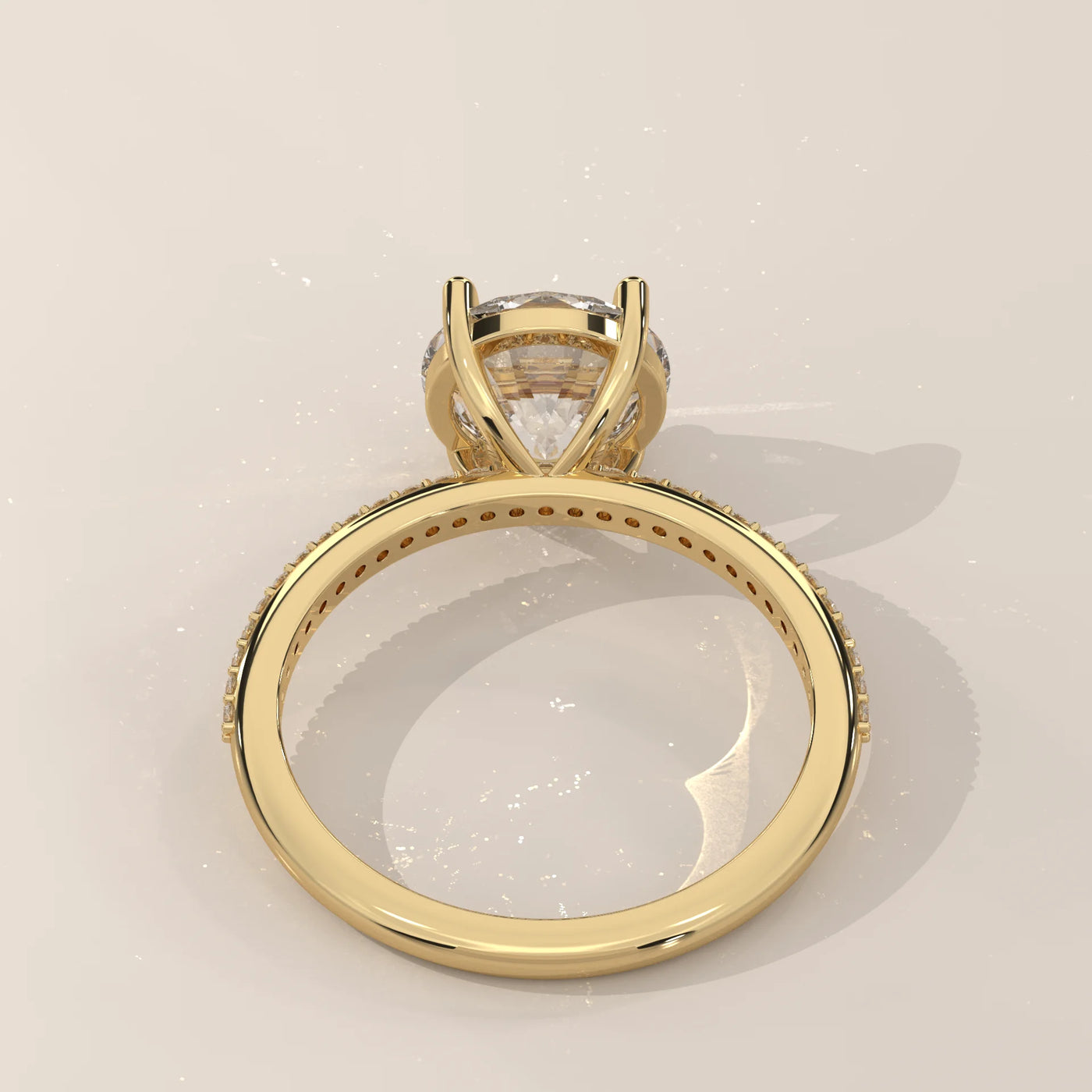 A classic 14k yellow gold ring with a large diamond and pave band.