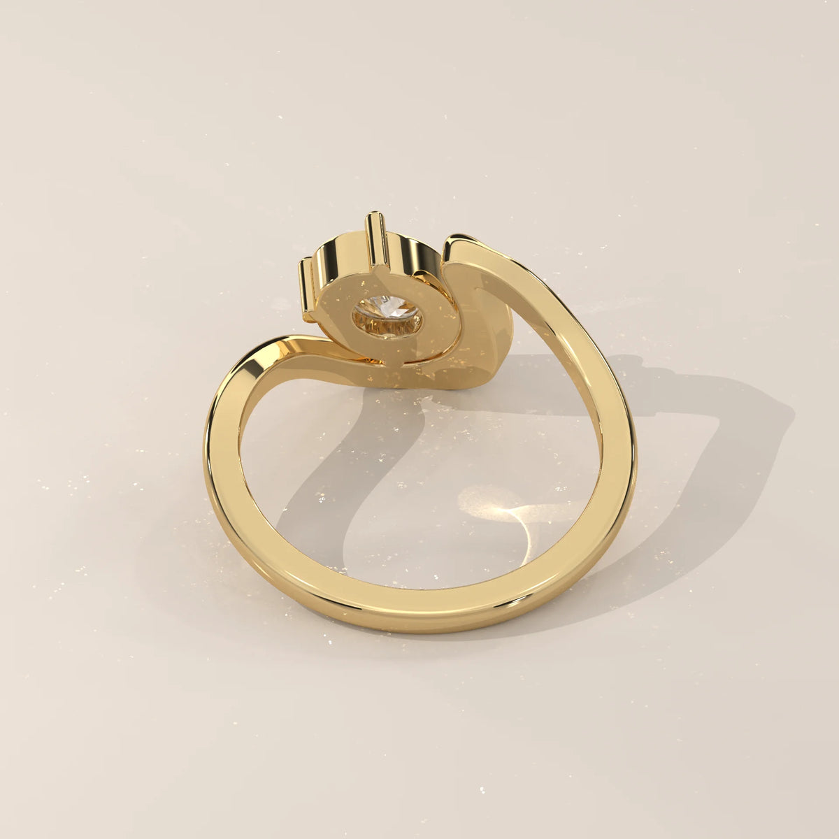Gold ring with a single diamond in a bypass setting.