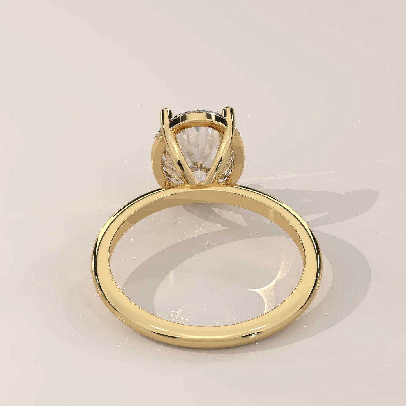 A classic solitaire diamond ring in 14k yellow gold with pavé band details.
