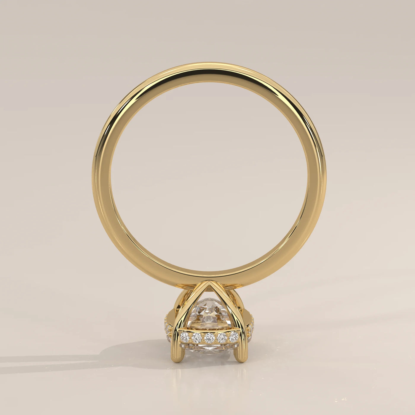 A classic solitaire diamond ring in 14k yellow gold with pavé band details.