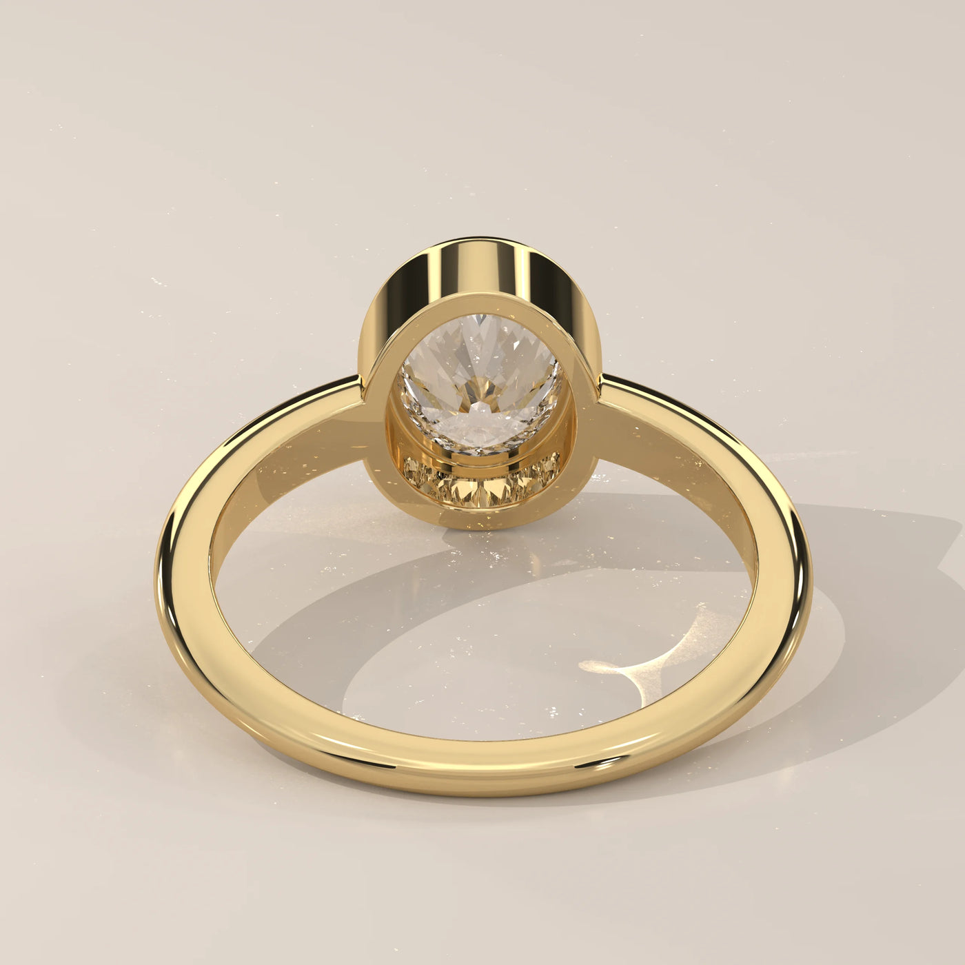 A yellow gold ring with a round, clear diamond set in a bezel.