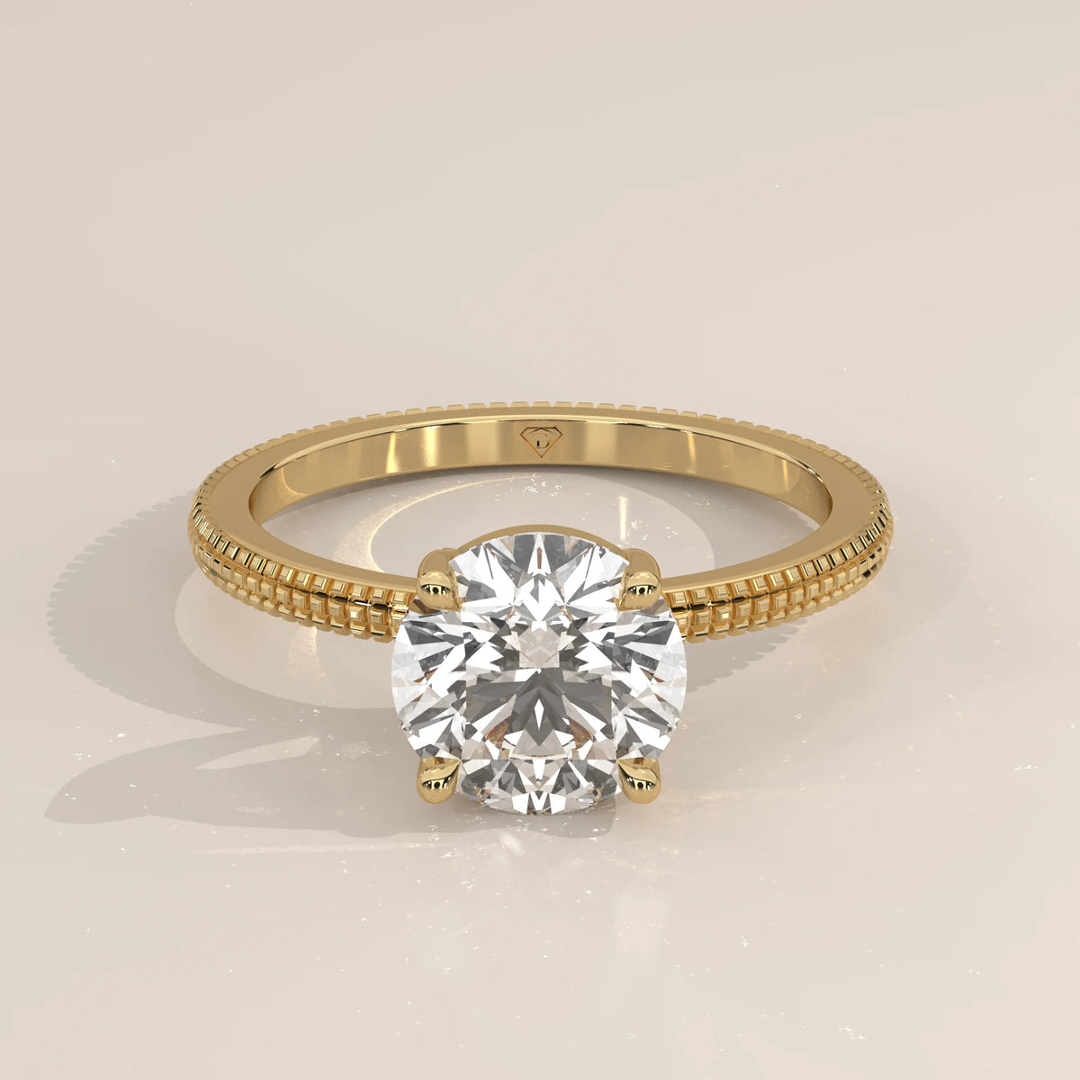 A classic solitaire diamond engagement ring in yellow gold with beaded detailing.