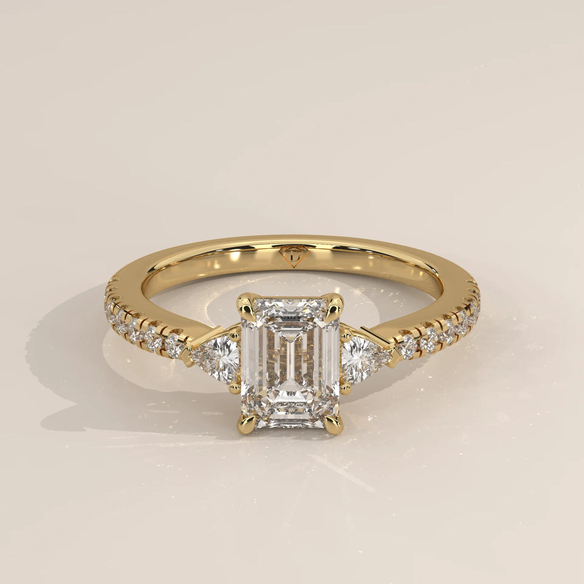 Emerald Cut Lab Grown Diamond Three Stone Ring with Trillion Sides in yellow gold, shown from the front.