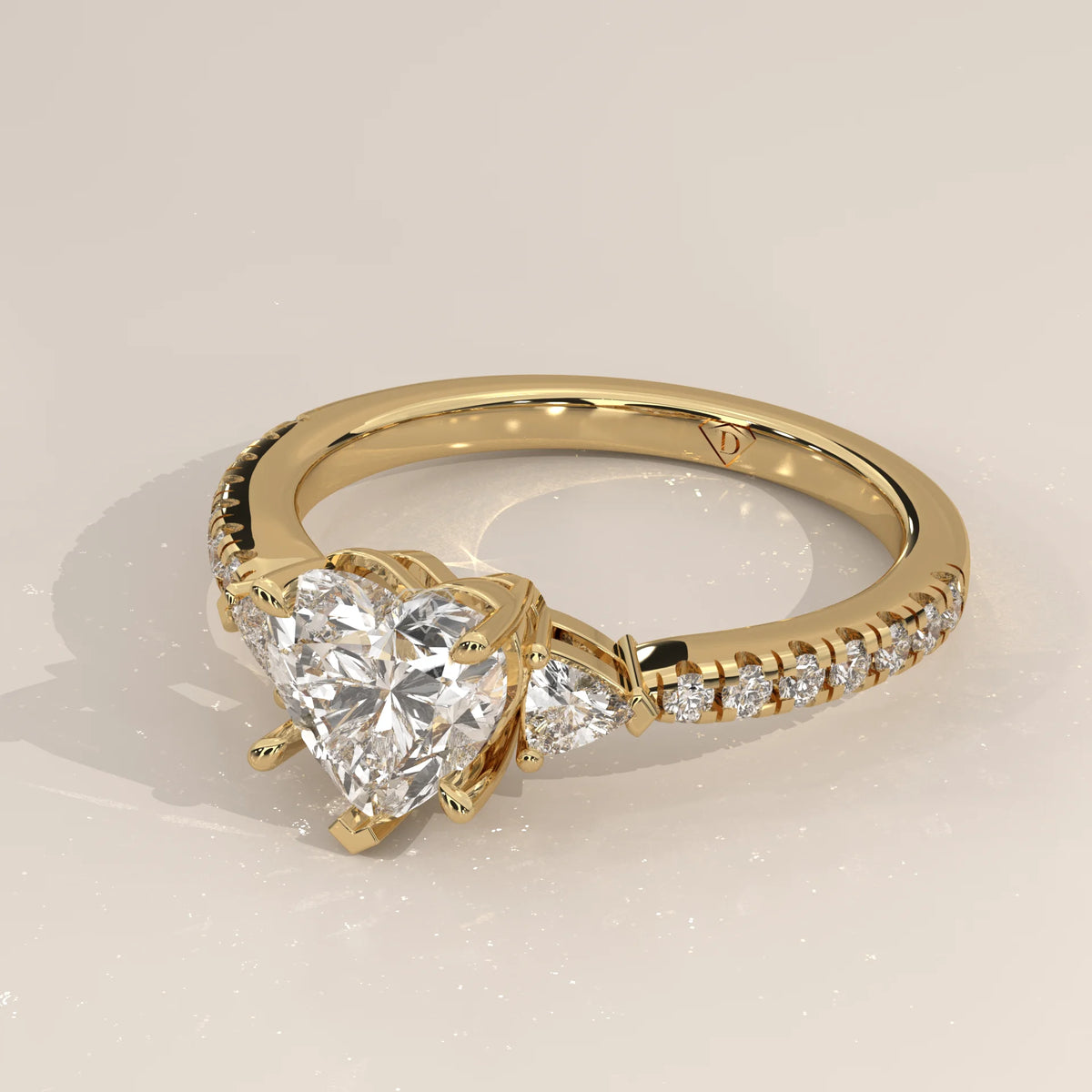 Heart Lab Grown Diamond Three Stone Ring with Trillion Sides in yellow gold, shown from the side.