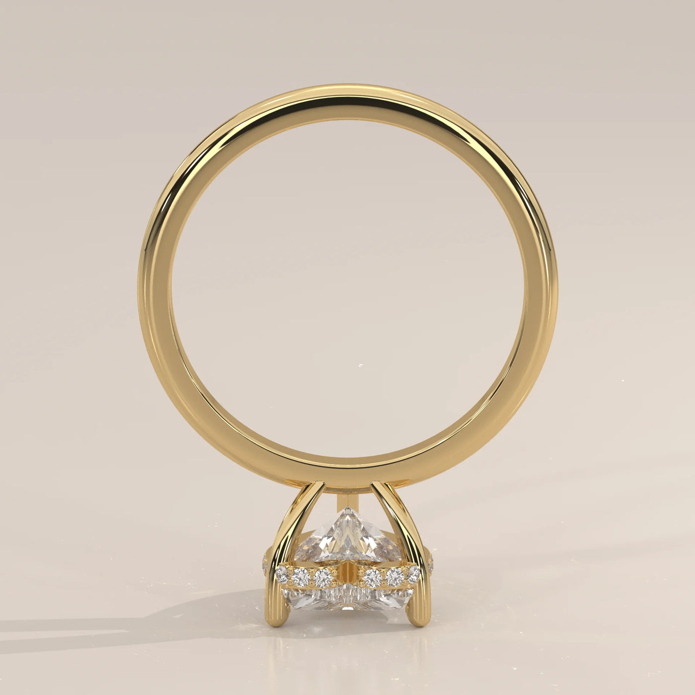 Yellow gold ring with three trillion-cut diamonds and small accent stones.