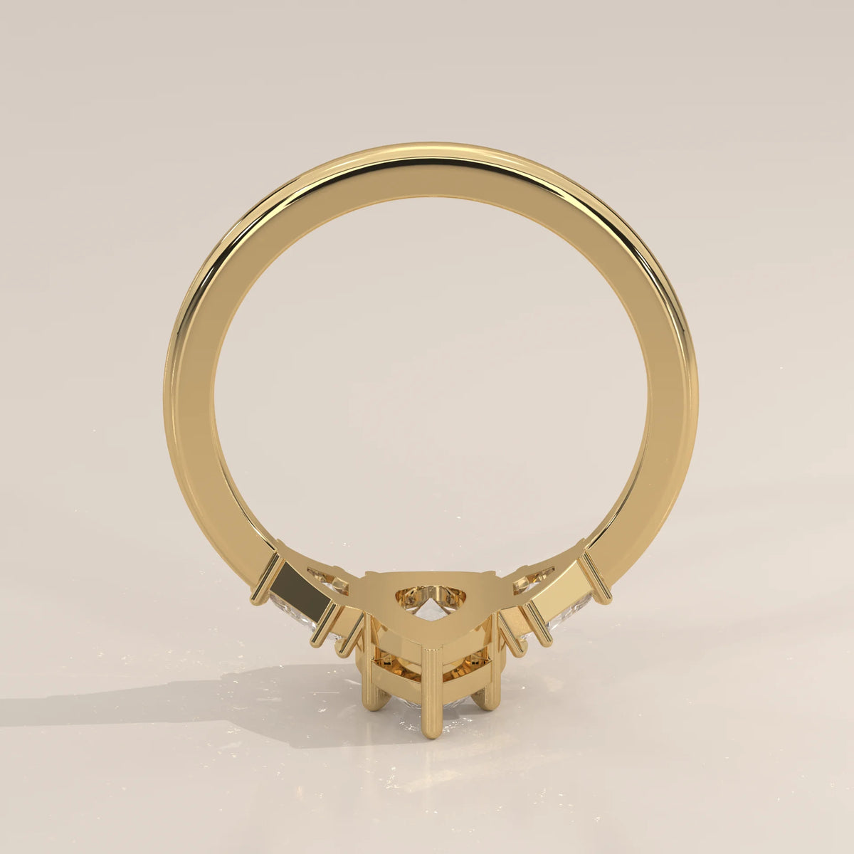 Pear Lab Grown Diamond Three Stone Ring with Shield Cut Sides in yellow gold, product photograph on a plain background.