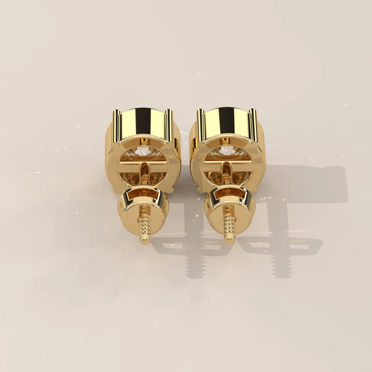 Pair of 14k yellow gold round diamond stud earrings with screw backs.