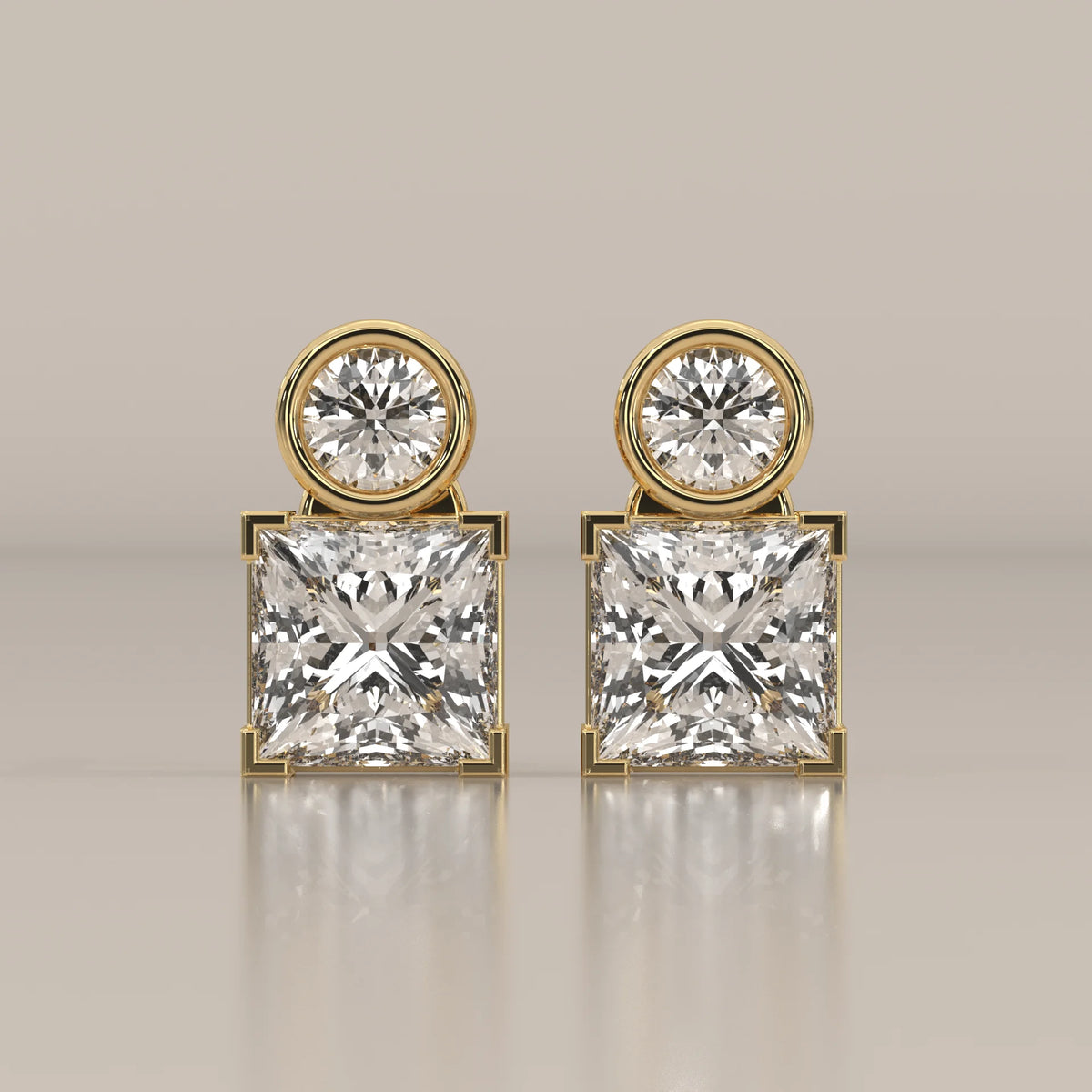 Round and Princess Two Stone Lab Grown Diamond Stud Earrings in yellow gold, shown from the front.