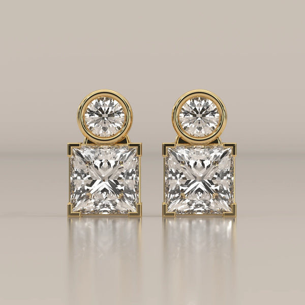 Round and Princess Two Stone Lab Grown Diamond Stud Earrings in yellow gold, shown from the front.