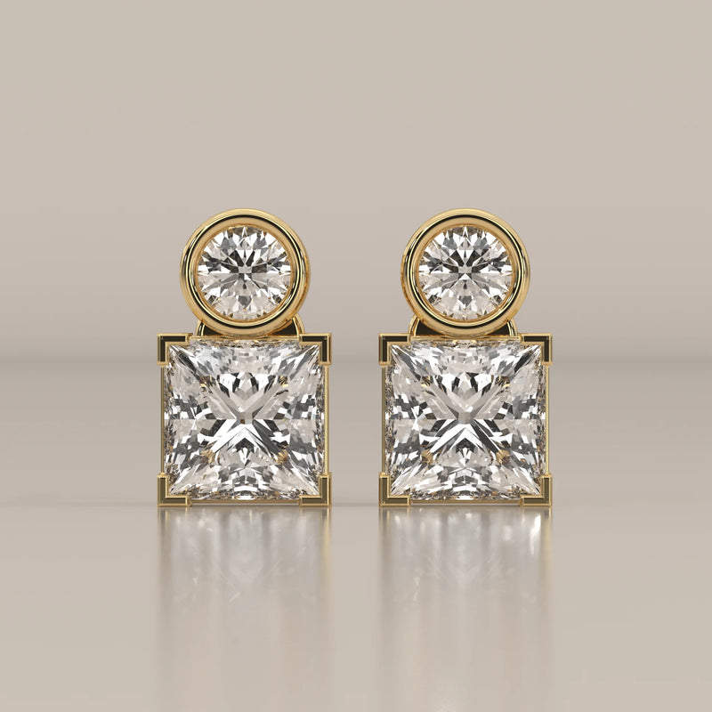 Round and Princess Two Stone Lab Grown Diamond Stud Earrings in yellow gold, shown from the front.