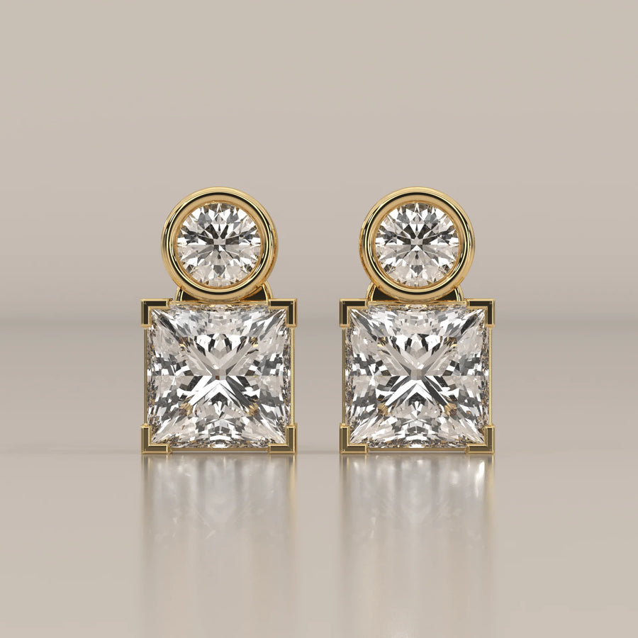 Round and Princess Two Stone Lab Grown Diamond Stud Earrings in yellow gold, shown from the front.