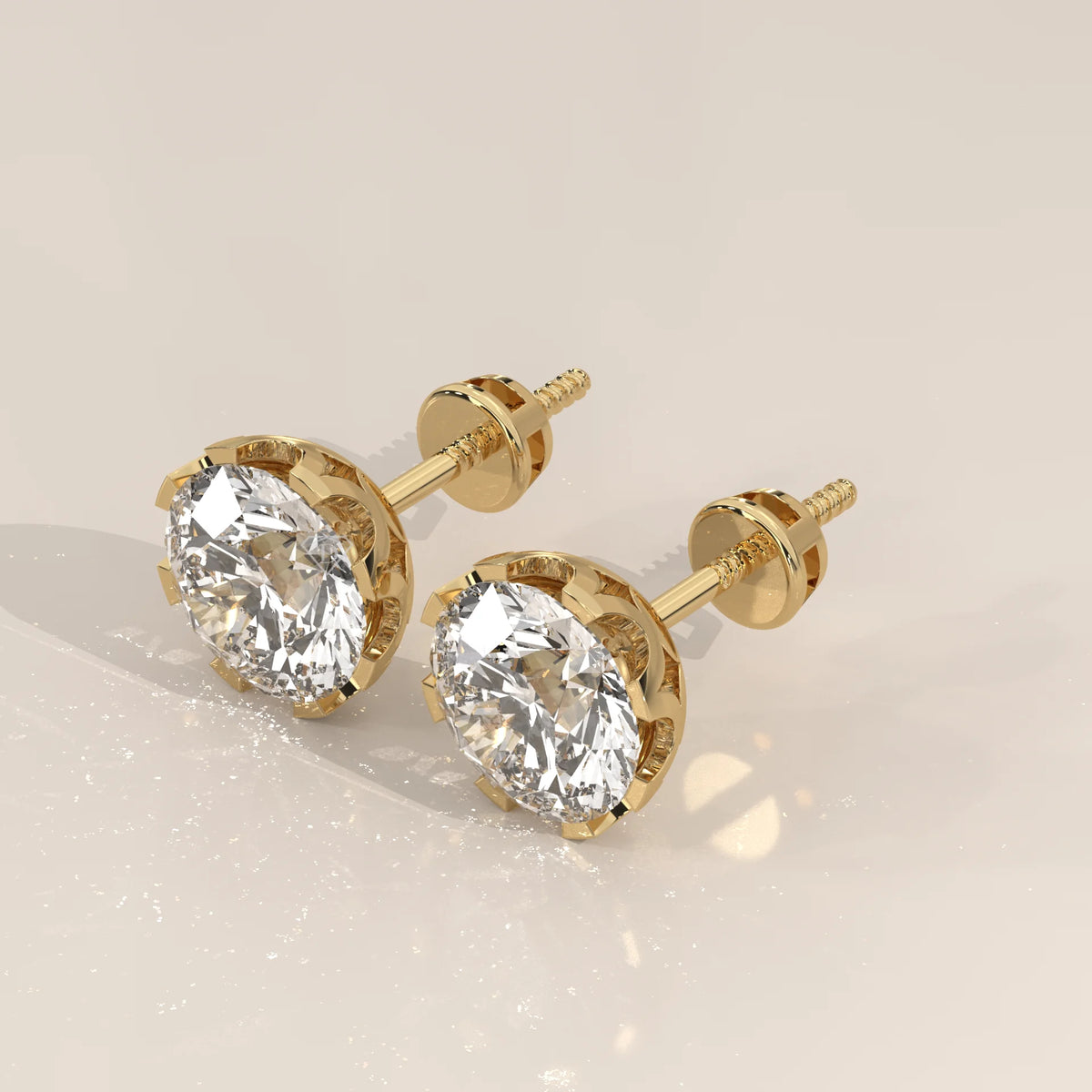 Round Solitaire Lab Grown Diamond Studs in a Crown Setting in yellow gold, shown at an angle.