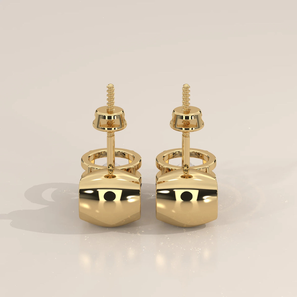 Round Solitaire Lab Grown Diamond Studs Under a Polished Gold Cap in yellow gold, studio photograph on a plain background.