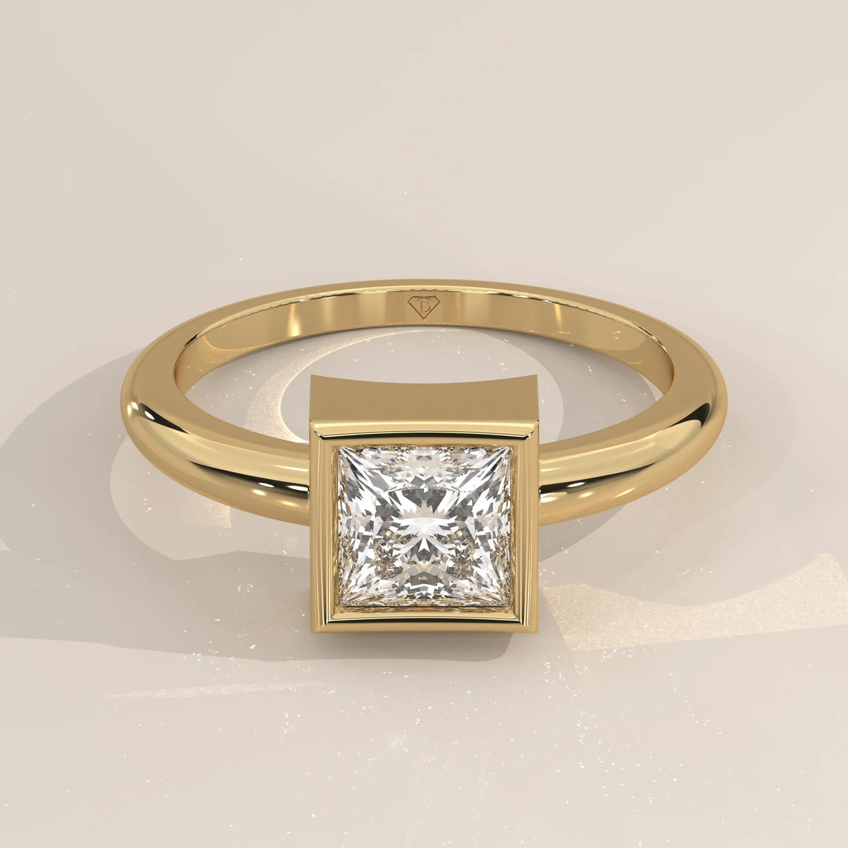 A polished gold ring with a square princess-cut diamond in a bezel setting.