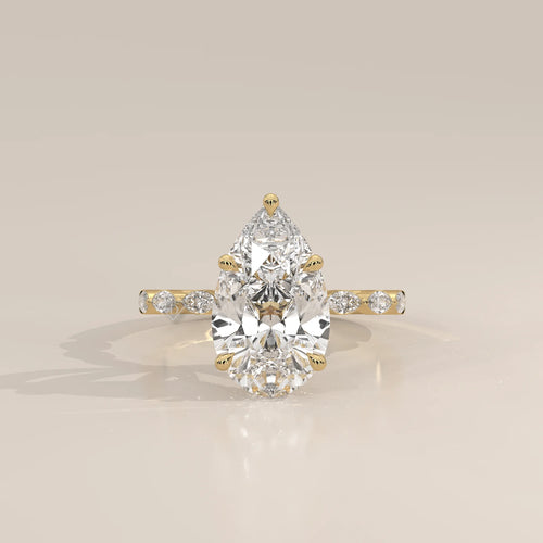Stlea 5 Carat Pear Lab Grown Diamond Ring, Bezel Marquise Band in yellow gold, photographed head-on.