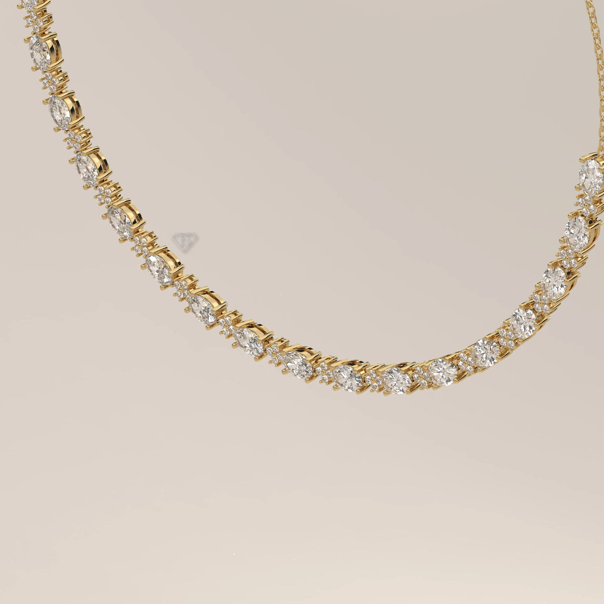 A graduated oval lab grown diamond necklace in yellow gold, shown at an angle.