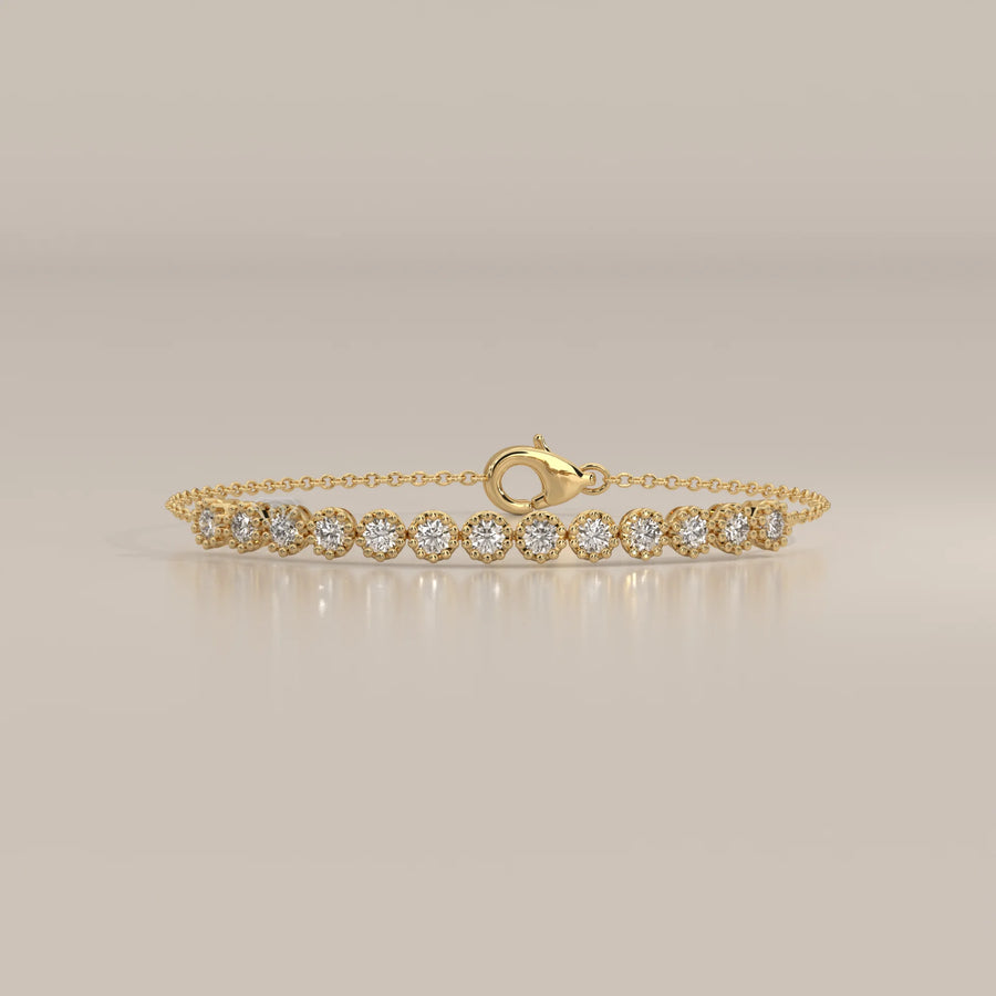 A delicate 14k gold bracelet featuring a line of round, brilliant-cut diamonds.