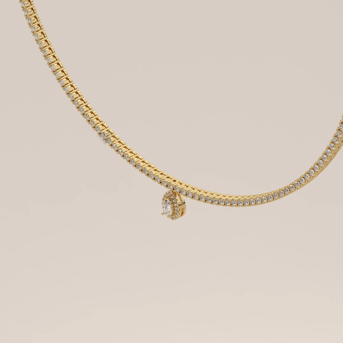 A pear halo lab grown diamond teardrop tennis necklace in yellow gold, viewed from overhead.