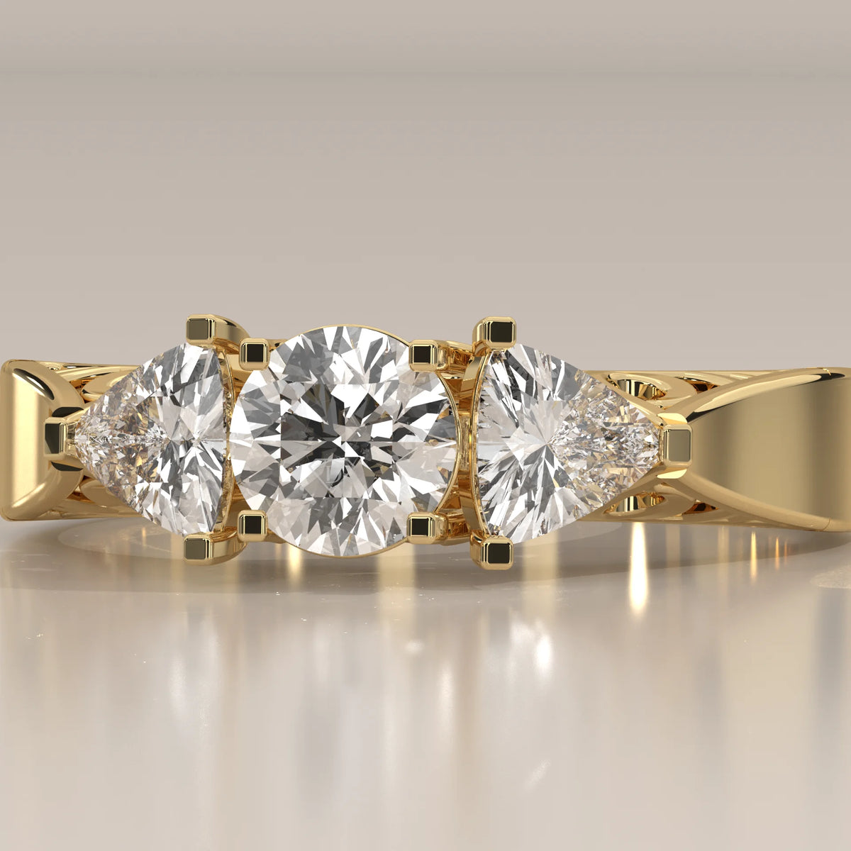 Round and Trillion Lab Grown Diamond Three Stone Filigree Ring in yellow gold, front view on a plain background.