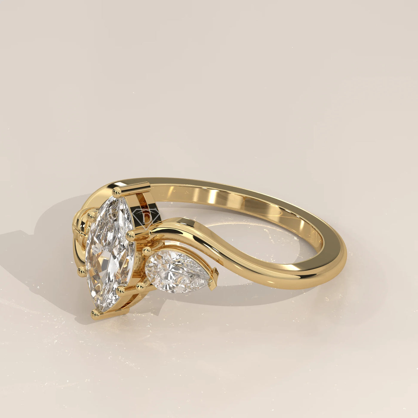 Gold ring with a marquise diamond and two pear-shaped diamonds.