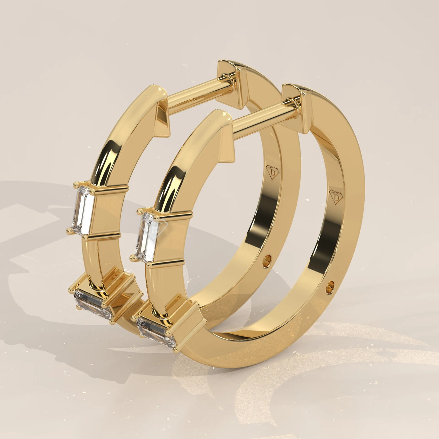 Three-Quarter View: Emerald Cut Diamond Huggie Hoop Earrings with Three-Stone Setting in Yellow Gold – Lab Grown – Driona Jewels