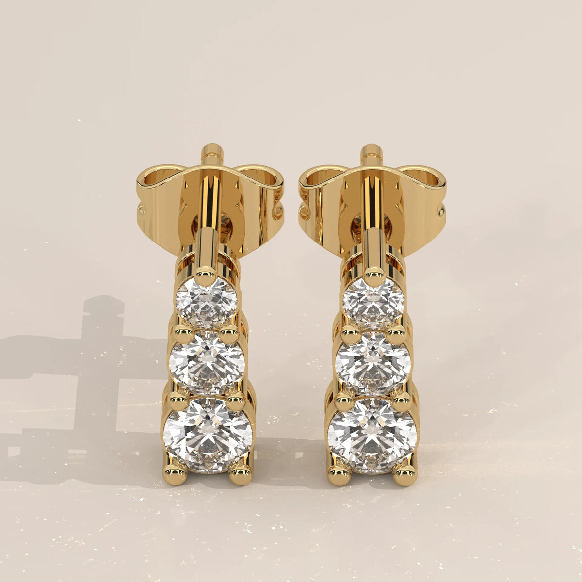 Pair Front View: Round Diamond Stud Earrings with Three-Stone Setting in Yellow Gold – Lab Grown – Driona Jewels