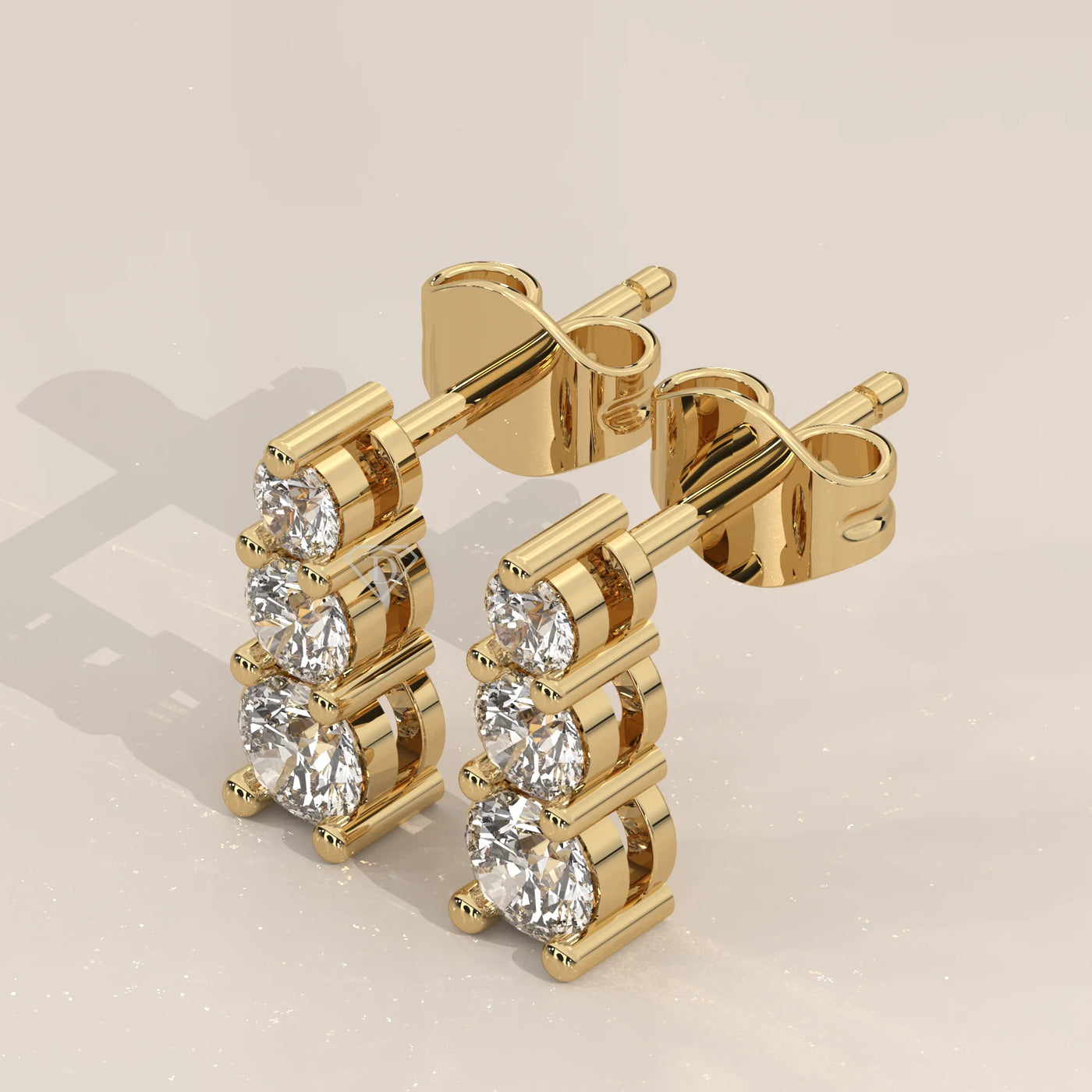 Three-Quarter View: Round Diamond Stud Earrings with Three-Stone Setting in Yellow Gold – Lab Grown – Driona Jewels