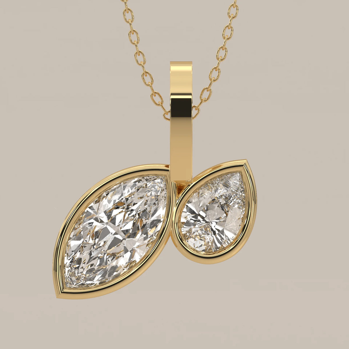 Toi et Moi Bezel Marquise and Pear Lab Grown Diamond Pendant in yellow gold, front view on a plain background.