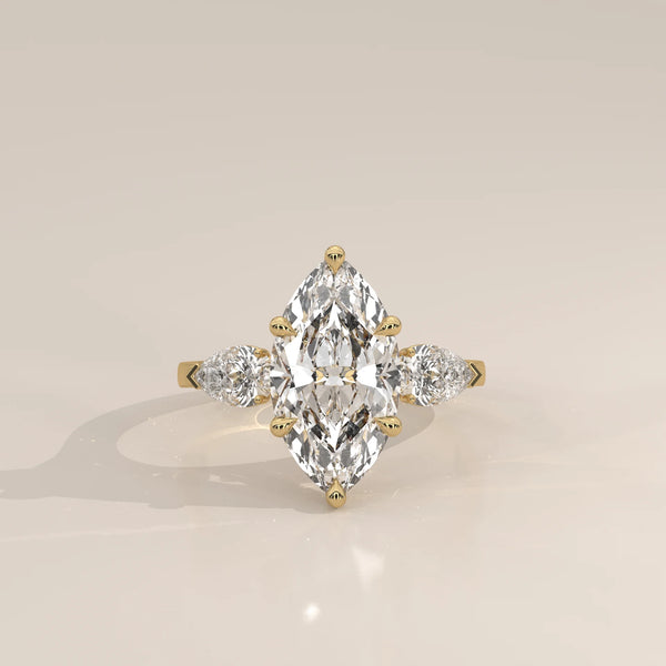 Umor 5 Carat Marquise Lab Grown Diamond Three Stone Ring, Pear Sides in yellow gold, photographed head-on.