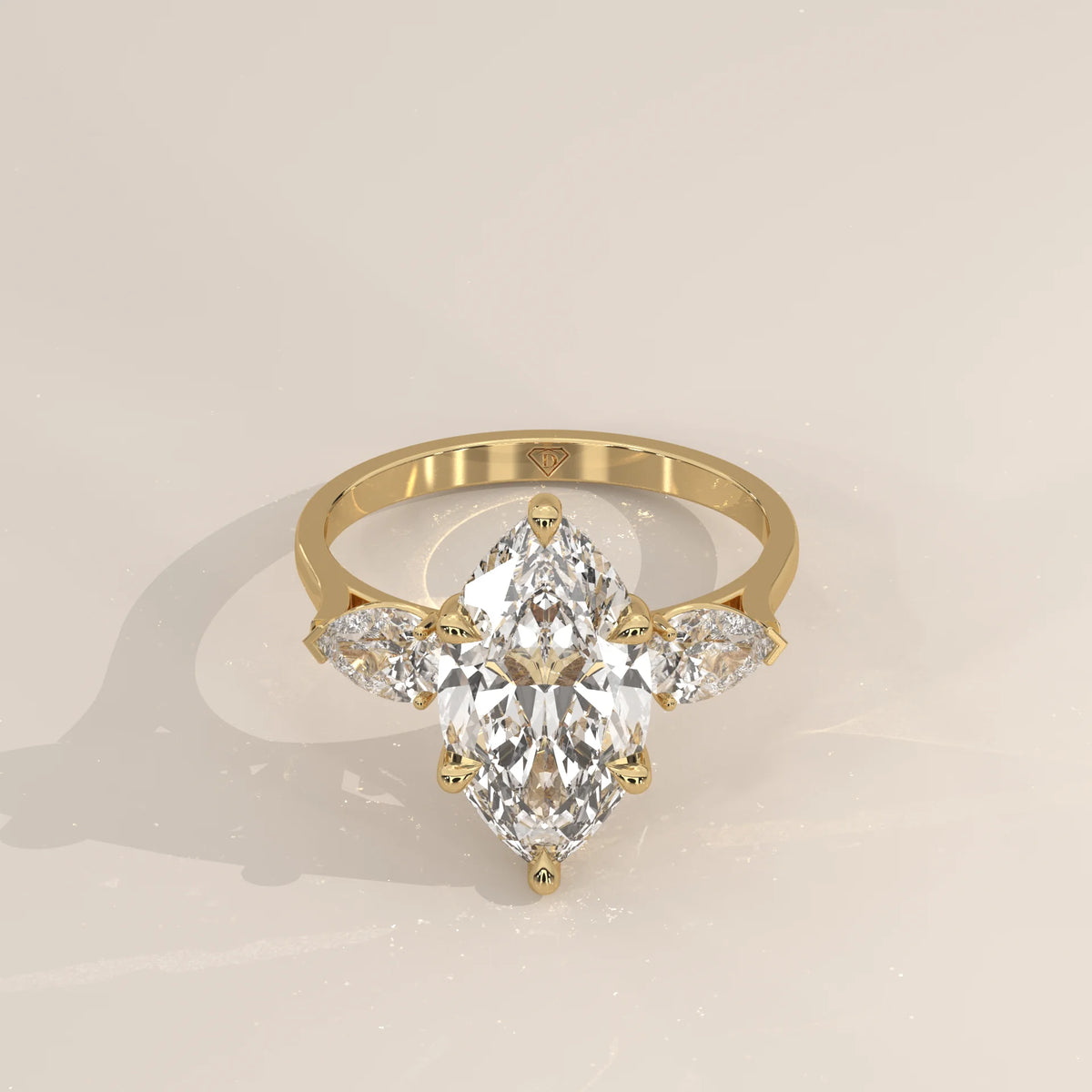Umor 5 Carat Marquise Lab Grown Diamond Three Stone Ring, Pear Sides in yellow gold, shown from the front.